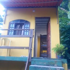 a house with a staircase leading up to a door at Suíte simples floresta verde in Angra dos Reis