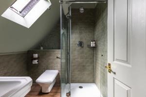 a bathroom with a shower with a toilet and a sink at The Bell & Stuart House in Stow on the Wold +47 photos