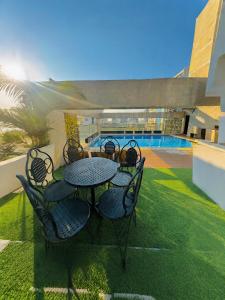 a patio with a table and chairs next to a pool at Dhaka Unique Regency in Dhaka
