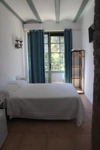 a bedroom with a white bed and a window at Lotel Casa Noble in Valencia
