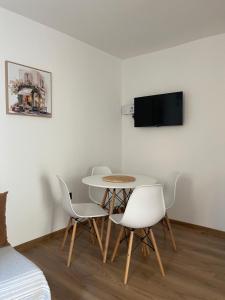 a white dining room with a table and chairs at Casa Mare in Prčanj +11 photos
