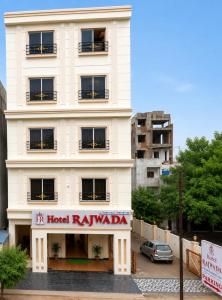 a white building with a hotel raleigh sign on it at Hotel Rajwada Nagpur in Nagpur