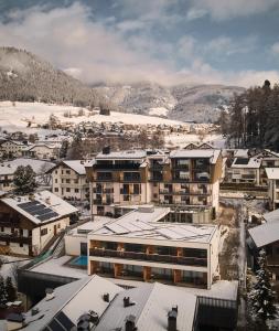 an aerial view of a town with snow covered buildings at MONTARA living mountain air in Terento