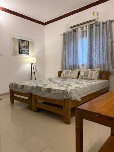 a bedroom with a bed and a window at Turtlenest by the Beach in Morjim