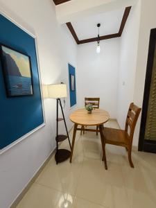 a living room with a table and a chair at Turtlenest by the Beach in Morjim +30 photos