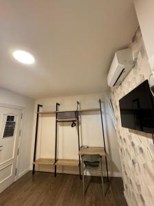 a room with two bunk beds and a tv at IRUÑA ROOMs in Pamplona