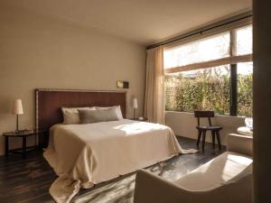 a bedroom with a bed and a large window at is.land Villa in Sanya