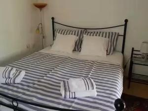 a bed with two pillows on top of it at Charming Villa in Jezera with Private Pool in Jezera