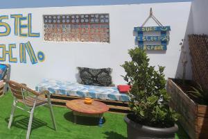 a room with a bed and a table and a chair at Rooftop Hostel Dakhla in Dakhla