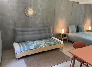 a room with two beds and a table and a table sidx sidx sidx at Le Moulin de St André in Saint-André-en-Morvan