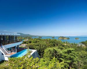 a house with a view of the water at Amakusa Tenku No Fune in Kami Amakusa