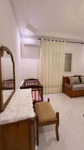 a room with a bed and a chair and a couch at Villa Korba 1st Floor in Korba