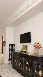 a living room with a tv on a wall at Villa Korba 1st Floor in Korba