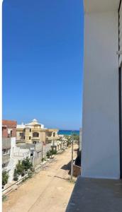 a view of a street with buildings and the ocean at Villa Korba 1st Floor in Korba