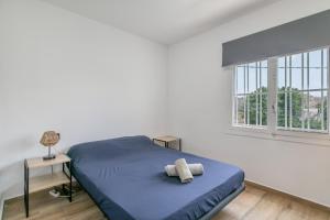a bedroom with a blue bed and a window at Casa di soza in Busot +33 photos