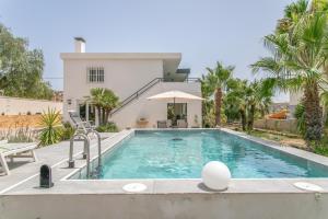 a swimming pool in front of a house at Casa di soza in Busot