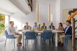a group of people sitting around a table at Villa de rêve - Climatisation - Sauna - Spa - babyfoot - Arcade in Quatzenheim +84 photos