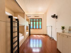 a dorm room with bunk beds and a window at Commune Lane Guesthouse, George Town in George Town