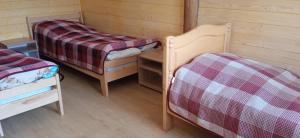 a room with two beds and a table and chairs at Бойківський двір in Yasenitsa Zamkova +10 photos