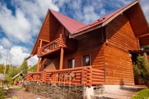 a large wooden house with a gambrel roof at Бойківський двір in Yasenitsa Zamkova