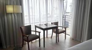 a room with a table and two chairs and a lamp at Huntington Beach Inn in Huntington Beach +229 photos