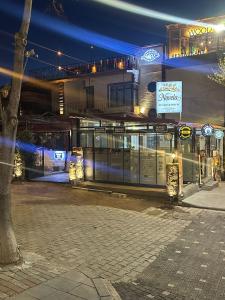 an empty street in front of a building at night at novela in stone house in Uçhisar