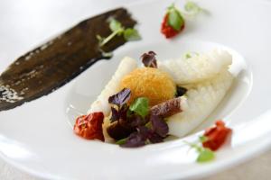 a white plate with some food on it with a knife at Amakusa Tenku No Fune in Kami Amakusa