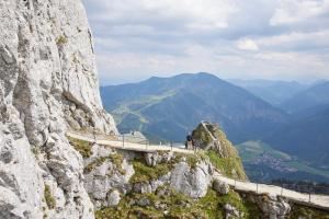 a person on a bridge on a mountain at Das Bayrischzell Familotel Oberbayern in Bayrischzell