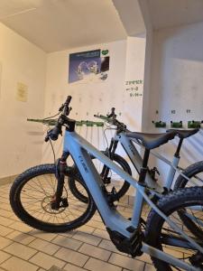 a blue bike is parked in a room at Hotel-Pension Asingerhof in Schladming