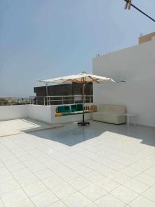 a patio with an umbrella on top of a building at Villa Korba 2nd Floor in Korba