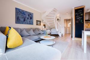 a living room with a couch and a staircase at Ülleken in Fehmarn