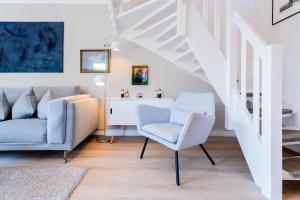 a living room with a chair and a couch at Ülleken in Fehmarn +34 photos