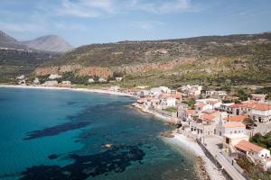 an aerial view of a beach with houses and the ocean at Aura Seafront Villa in Neo Itilo