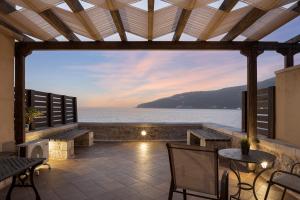 a patio with a view of the water at Aura Seafront Villa in Neo Itilo