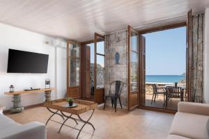 a living room with a view of the ocean at Aura Seafront Villa in Neo Itilo +49 photos