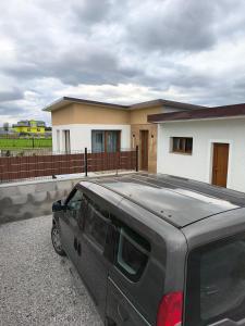 a gray suv parked in front of a house at Dubrowes cottage in Bobrów +4 photos