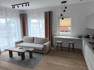 a living room with a couch and a table at Dubrowes cottage in Bobrów
