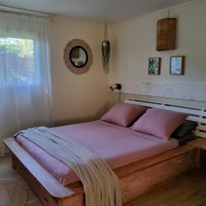 a bedroom with a large bed with pink sheets at LE RUBINJO 2 in Saint-Benoît +60 photos