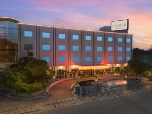 a large building with a hotel in front of it at Ginger Agra, Fatehabad Road in Agra