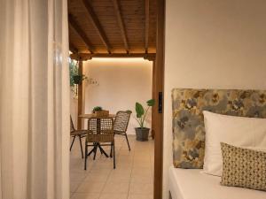 a bedroom with a bed and a table and chairs at Pansion Katerina in Ouranoupoli