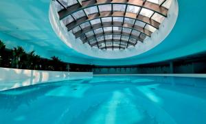 an indoor swimming pool with a domed ceiling at Hanza Tower - Luxurious Apartment 60m2 - 15th Floor City View in Szczecin