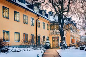 a building with snow on the ground in front of it at Hotel Skeppsholmen, Stockholm, a Member of Design Hotels in Stockholm