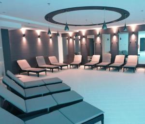 a waiting room with chairs and a row of lights at Hanza Tower - Luxurious Apartment 60m2 - 15th Floor City View in Szczecin +26 photos