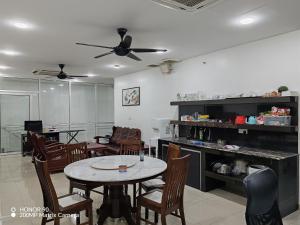 a dining room with a table and chairs at Arkid 10 Guesthouse in Ipoh