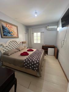 a bedroom with a bed and a television in it at Pousada e Museu JK in Ubajara