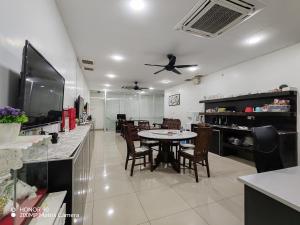 a kitchen and dining room with a table and chairs at Arkid 10 Guesthouse in Ipoh