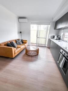 a living room with a couch and a table at The Sierra in Dunsborough