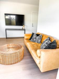 a living room with a couch and a large ottoman at The Sierra in Dunsborough