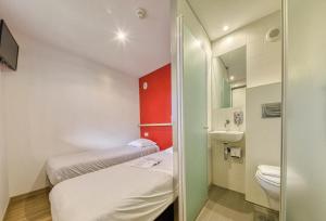a small room with two beds and a toilet at UNISOTEL Le Havre in Le Havre +19 photos