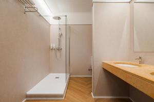 a bathroom with a glass shower and a sink at B&B HOTEL Sado Setúbal in Setúbal +42 photos